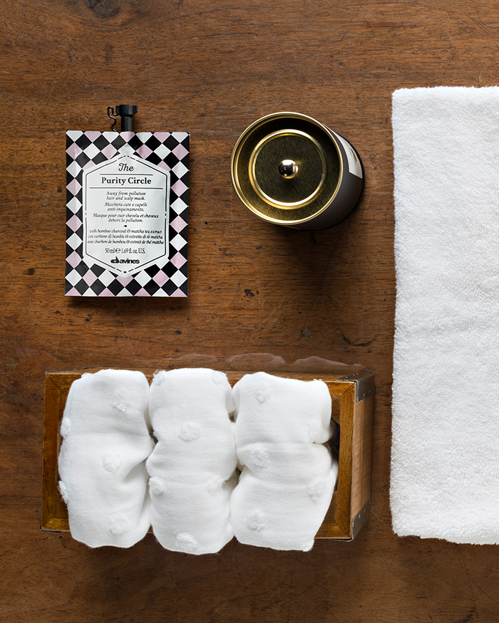 Haarmasken richtig anwenden - Stil-life Foto einer Davines Haarmaske und mehreren weissen Handtüchern